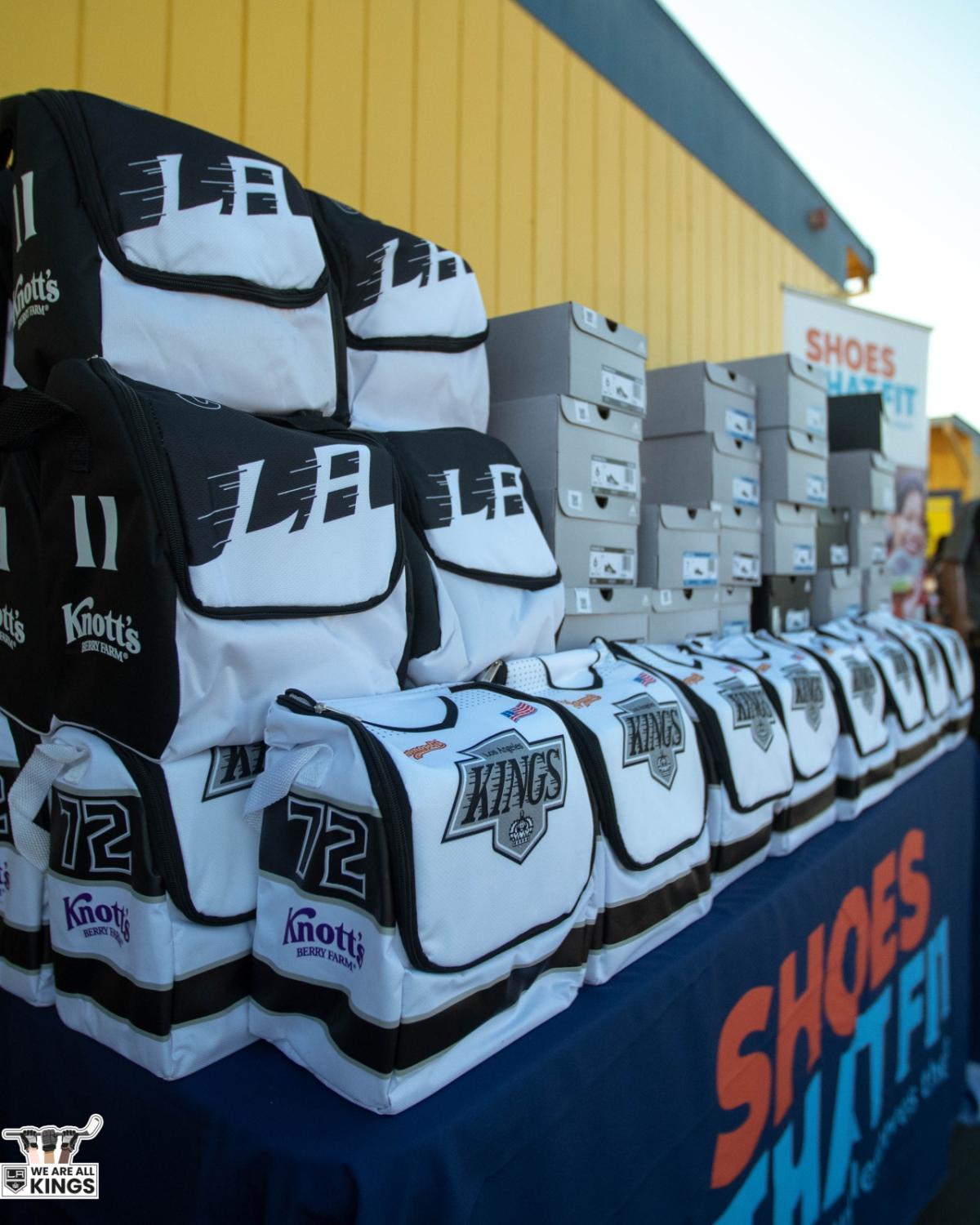 LA Kings lunchboxes and adidas sneakers are stacked prior to distribution to students at Longfellow Elementary School in Compton, Calif. 