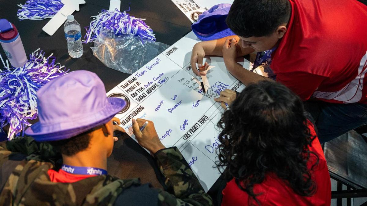 Three students working together on a project