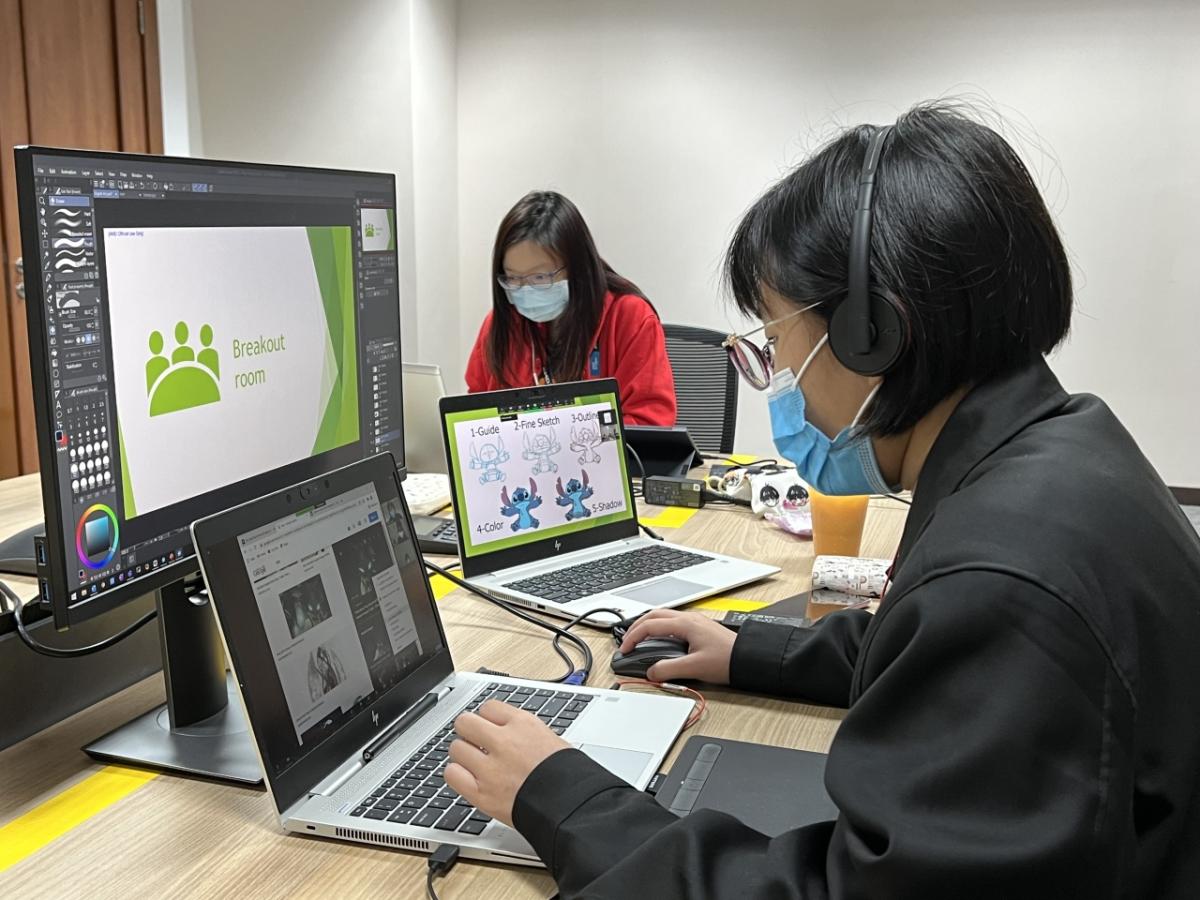 two people working on their computers