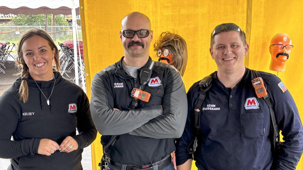 From left, Personal Safety Professionals Kelsey Mounts and David Janak, and Industrial Hygienist Adam Overgaard pose for a photo at the 2025 Safety Fair at the St. Paul Park refinery. " "