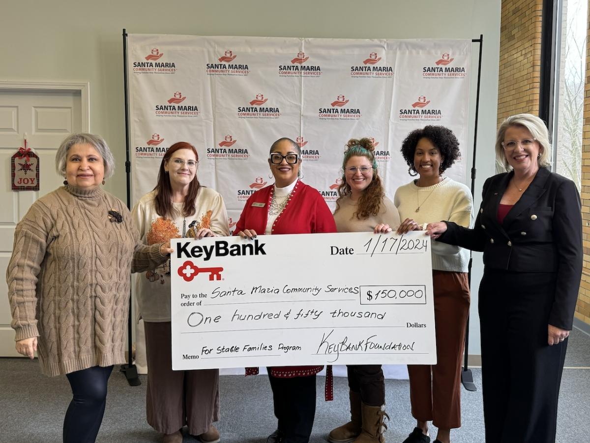 Representatives from KeyBank and Santa Maria Community Services shown with a $150,000 grant check.