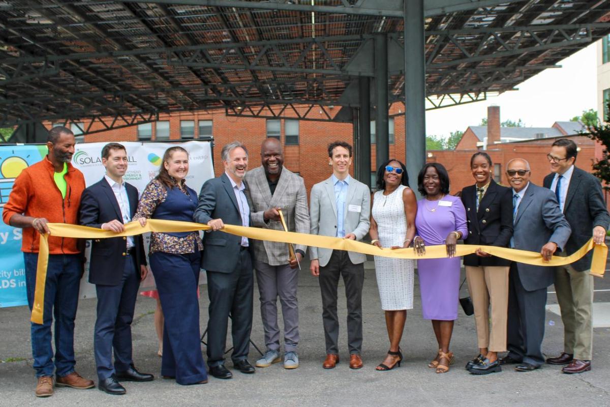 Groundswell, in partnership with Sargent Memorial Presbyterian Church, SunLight General Capital, and the Office of the People's Counsel, held a ribbon cutting to celebrate the completion of the solar array at Sargent Memorial Presbyterian Church on Friday. The completion of the community solar project marks a major milestone for affordable clean energy in the District. (Photo by Alicia B. Hill | Groundswell) Group of people at ribbon cutting celebration for the completion of the solar array at Sargent Memorial Presbyterian Church