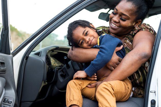 SaverLife launches a free mobile app to help working families save money and build wealth. Mother with child