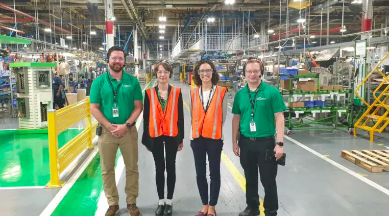 Schneider Electric employees standing in a factory