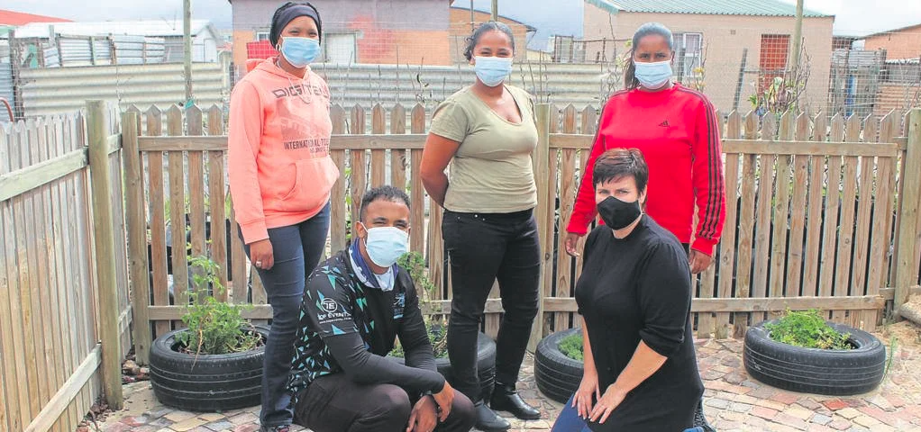 Carla Martin, Michael Owen Dyson, Mikayle Booysen, Leanne Reid and Merle Africa at the handover of food parcels at Children’s House of Lavender Hill. PHOTO: Racine Edwardes