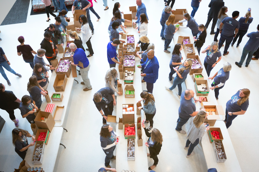 Fifth Third Bank employees pack food in the atrium of Fifth Third Center in Cincinnati on May 3, 2022, or Fifth Third Day. Overhead photo of people packing food