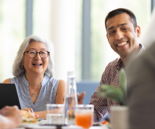 Woman and man smiling in a meeting