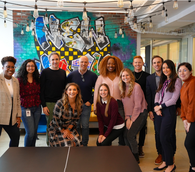 Expedia Group employees standing with Michael Davis Velasco and Peter Kern following an Inclusion & Diversity Town Hall.