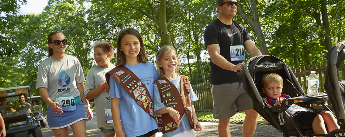 Group of people smiling and walking