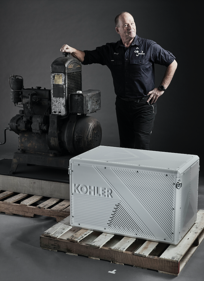 Robert Swan standing behind Kohler-branded engine