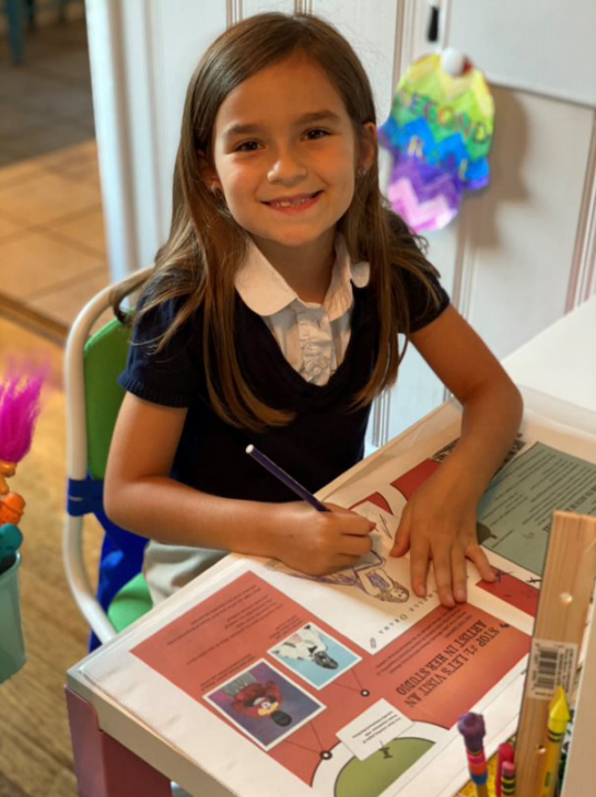 Girl coloring in her guide