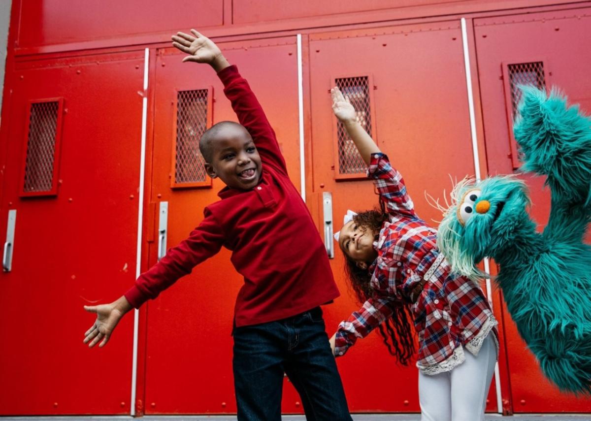 Kids dancing with Sesame Street character