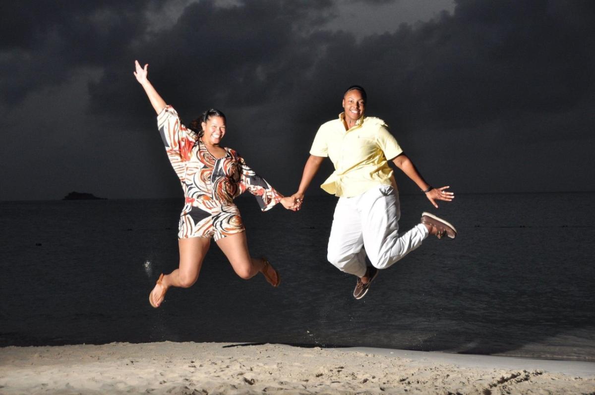Shae (right) and her wife, Taralyn (left), jumping in the air