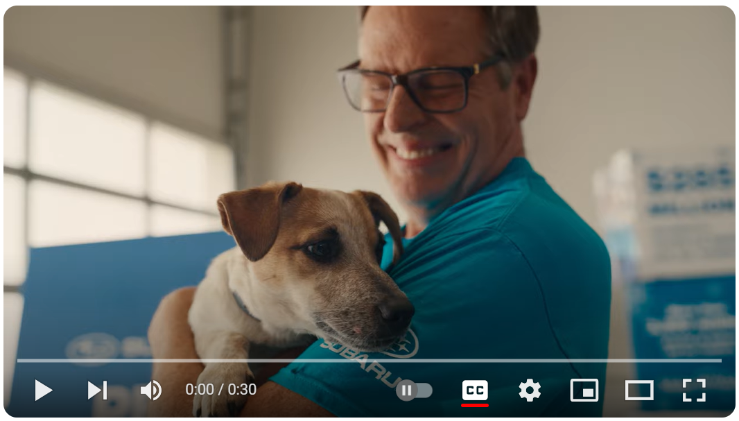 Smiling person holding a Jack Russell terrier