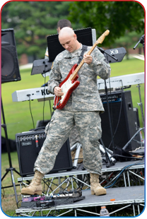 Shawn Mills, Principal Application Engineer, on stage playing the guitar 