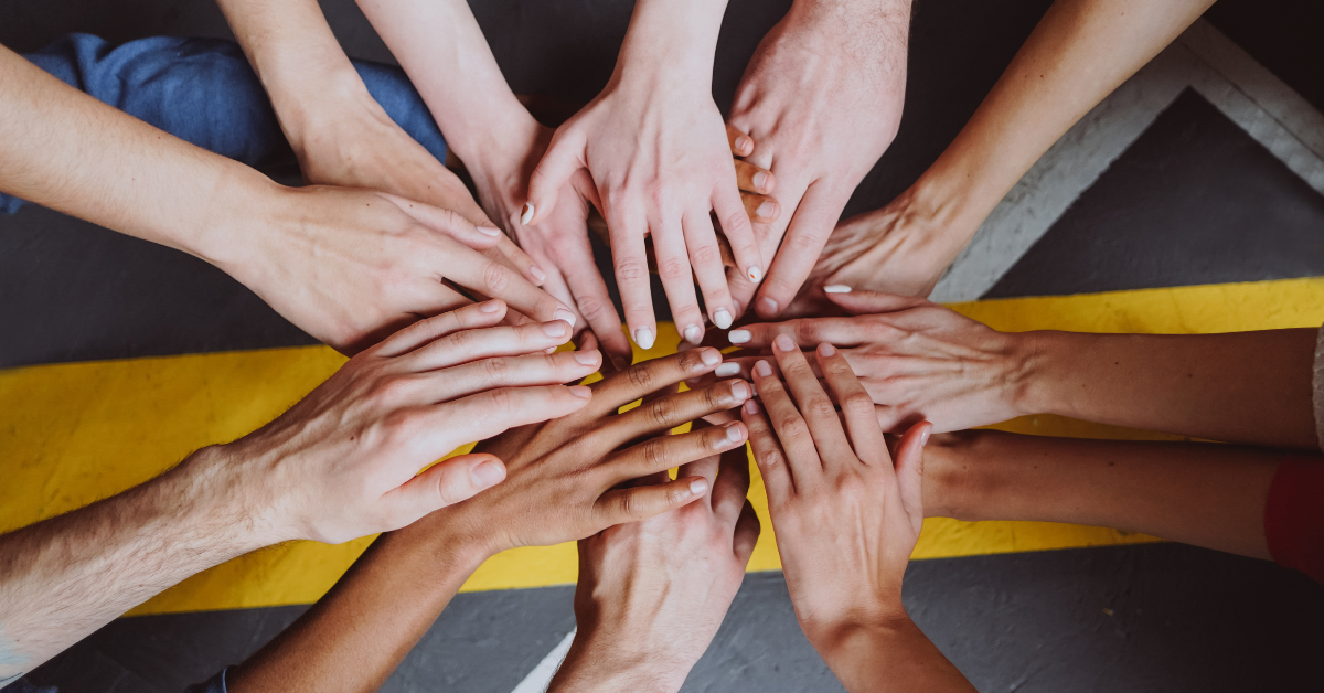 Multiple hands coalescing to portray diversity and inclusion
