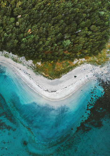 Blue waves crashing into a beach.