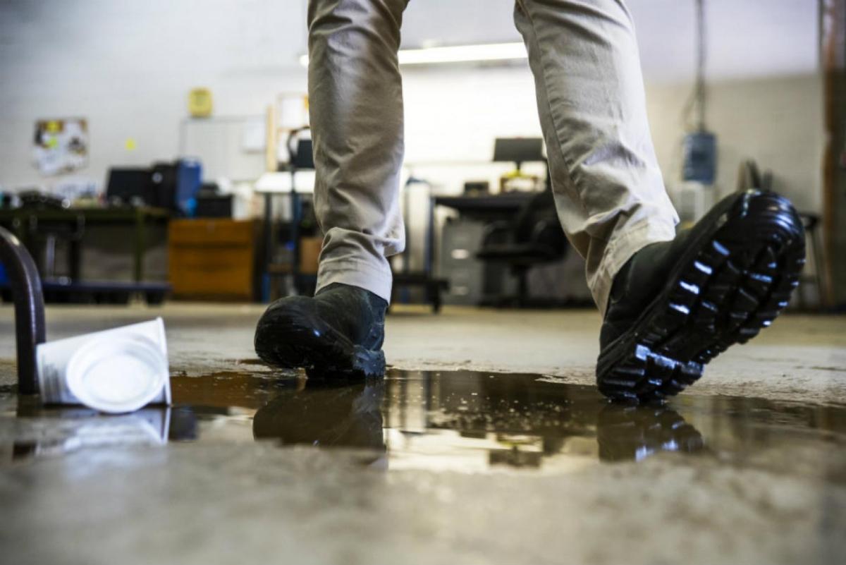 a person slipping on a wet floor