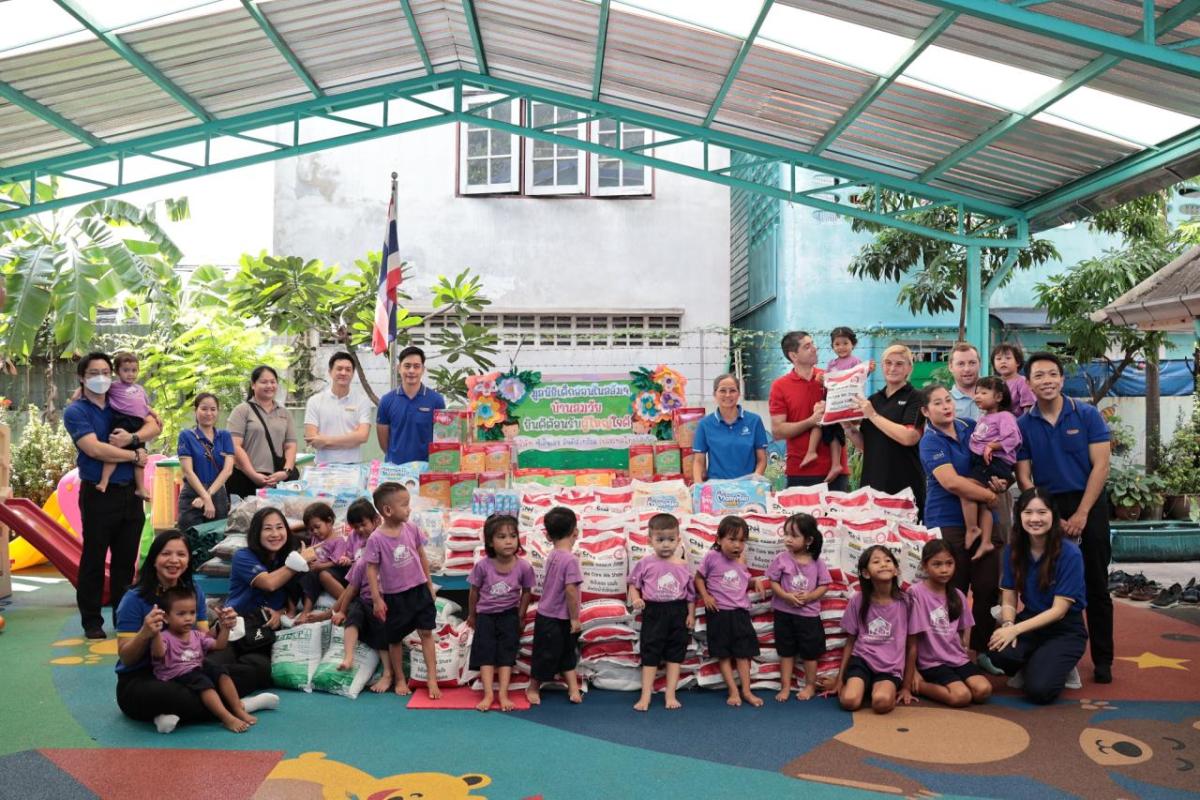 Adults and young children stood around bags of donation bags