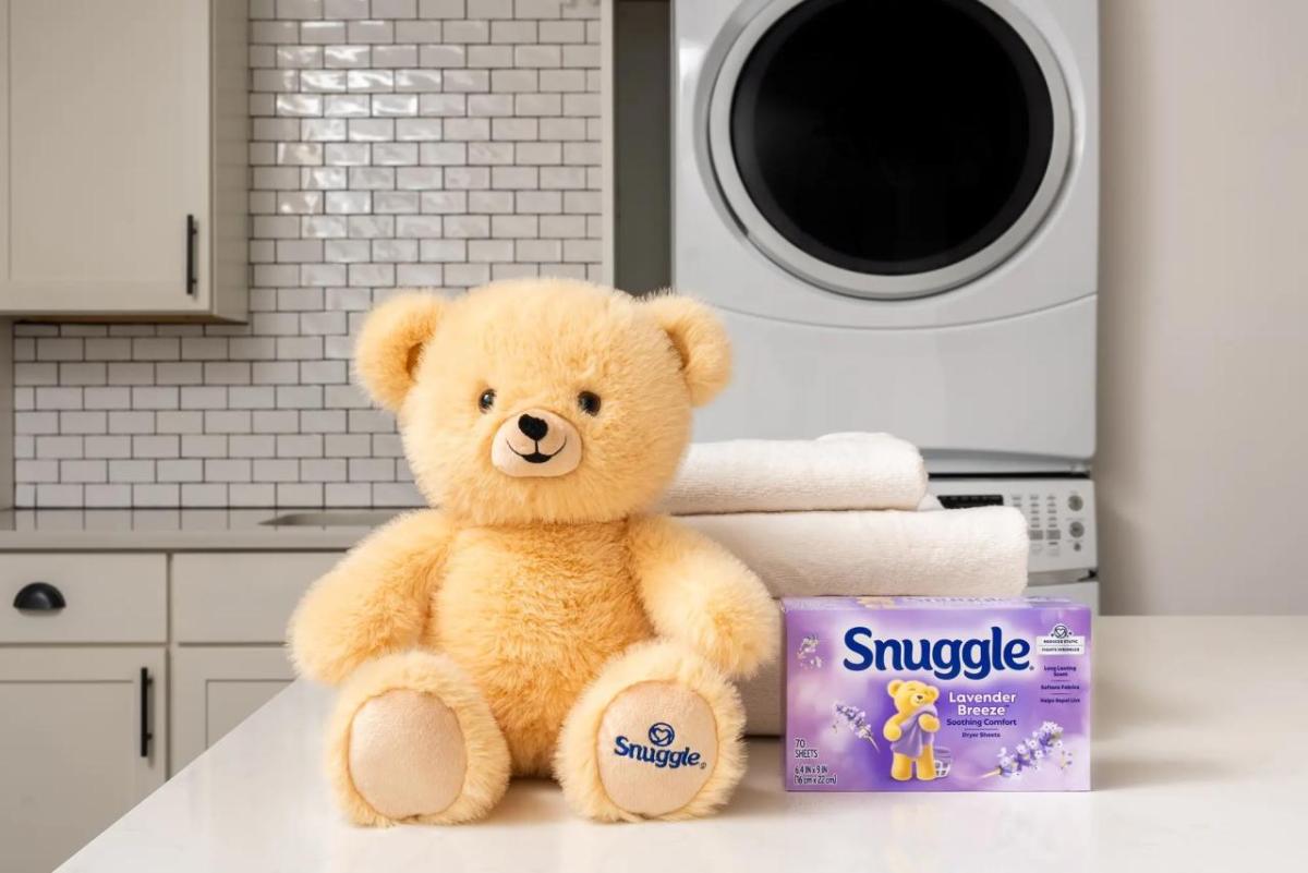 Snuggle bear next to folded towels and Snuggle products