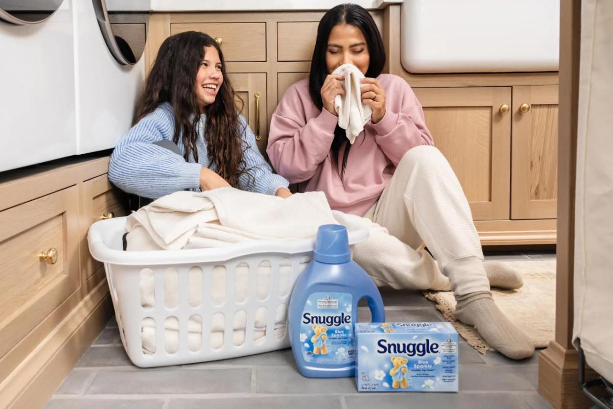 Family with laundry basket and Snuggle products