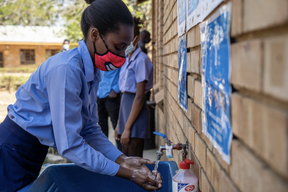 Schoolchildren using outdoor handwashing facilities at Ramauba Secondary School in the northwest part of the country. 