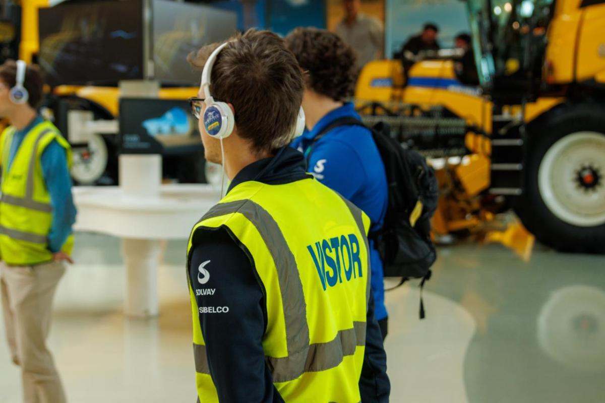 A person wearing a hi-vis vest and earphones 