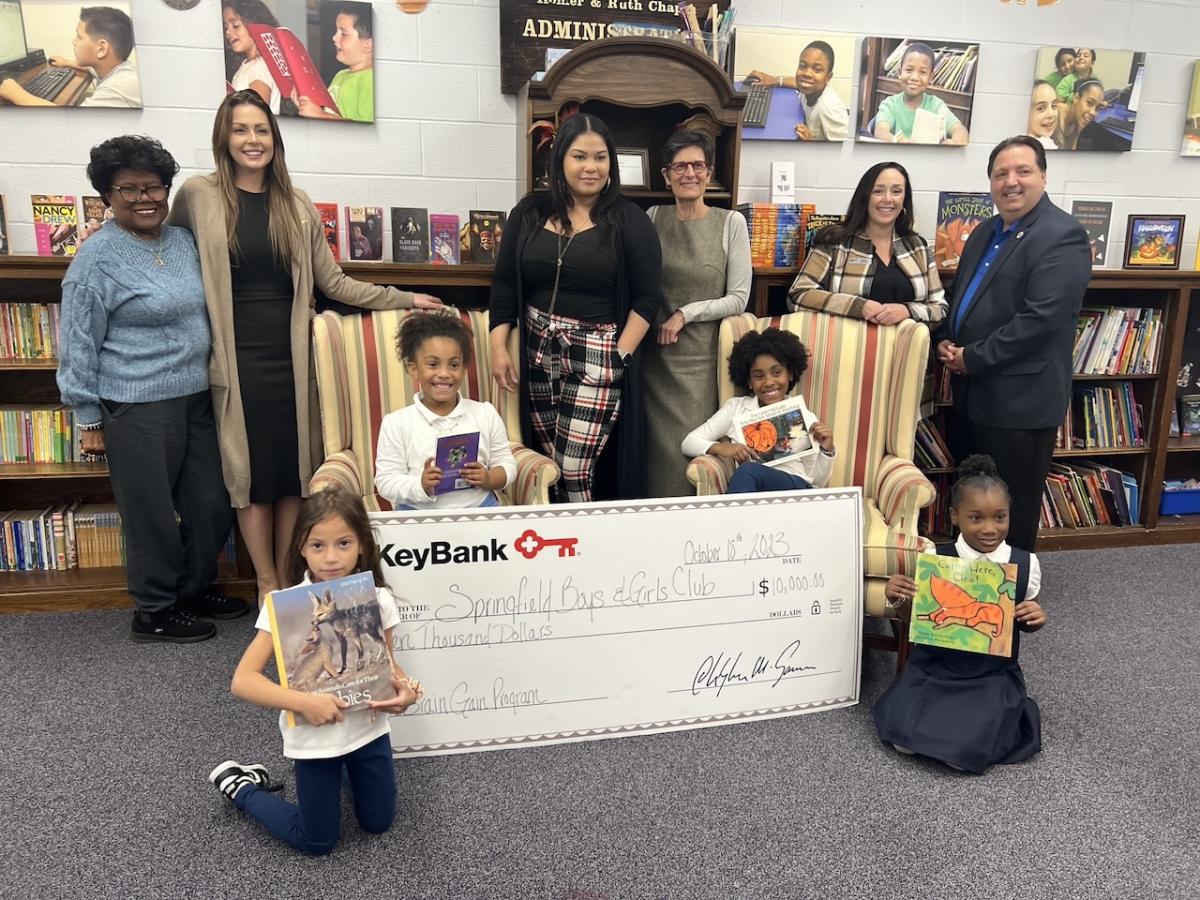 (from left) Springfield Boys & Girls Club board member Aleana Laster; KeyBank Corporate Responsibility Officer Analisha Michanczyk, Branch Manager Vanity Bryant; SBGC Director of Development Karen Natsios;  KeyBank Area Retail Leader Sarah Germini; and Springfield Boys & Girls Club Executive Director Vinnie Borello (far right), with students in the Brain Gain program.      