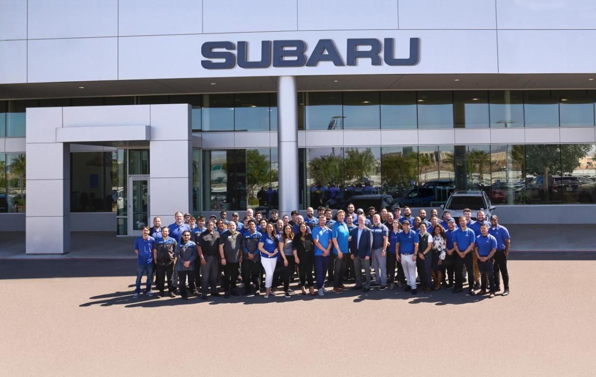 Group in front of a Subaru building