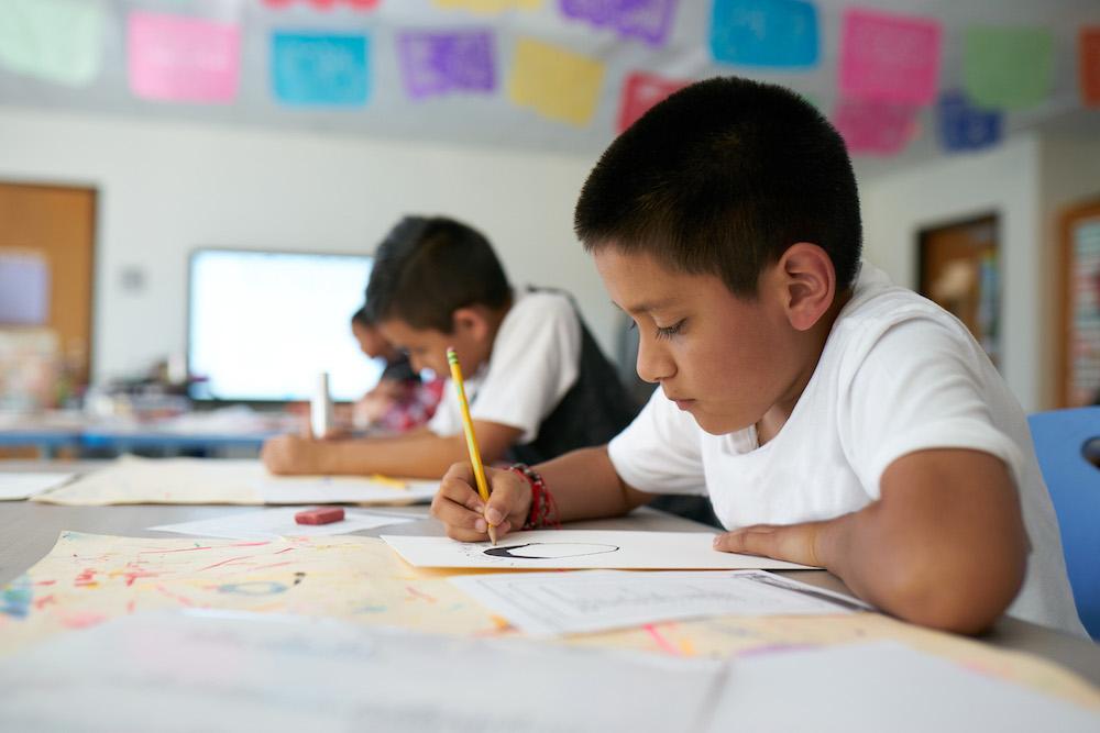 students writing in classroom