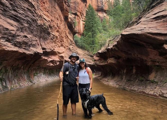 Photo of Suzeth Campos, her husband and dog taking a hike.