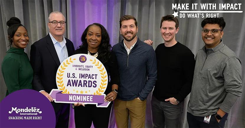 Sylvia Conner and five others posed, holding a sign "US Impact Awards Nominee".