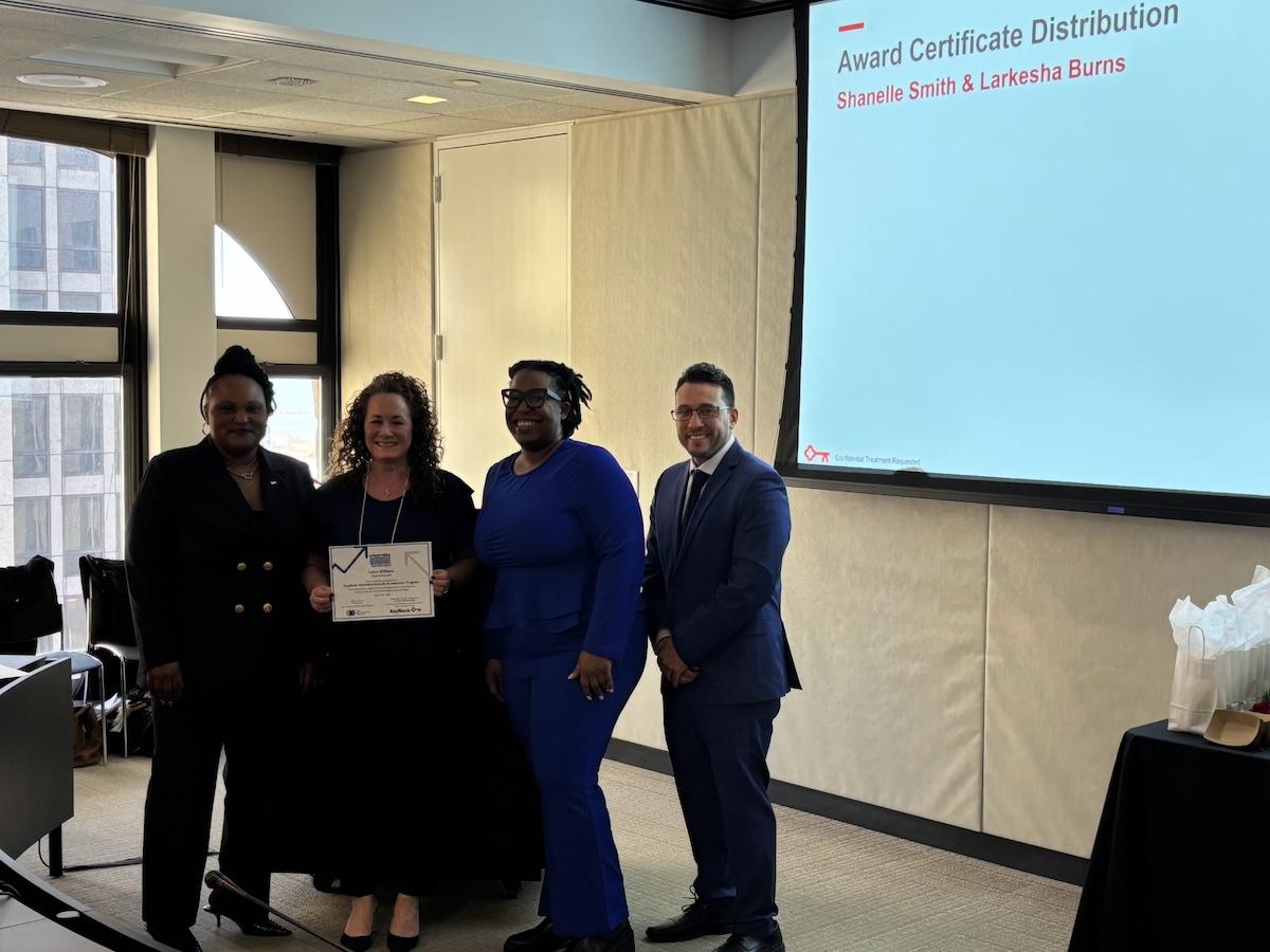 KeyBank and TAP representatives shown with the certificate.