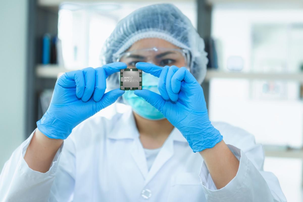 person in scrubs and gloves looking at a chip