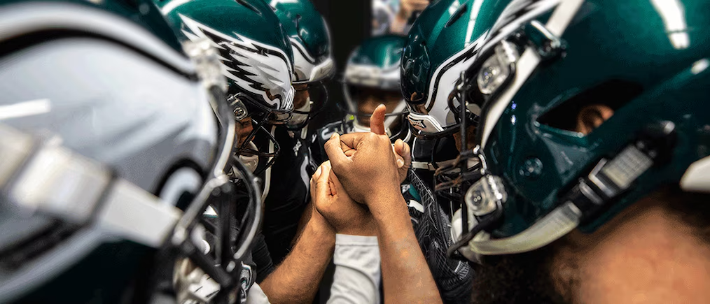 The Philadelphia Eagles shown in a huddle.