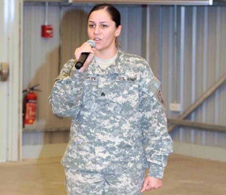 Marsha Smith talking into a microphone wearing a military uniform 