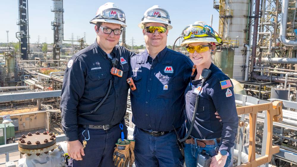 Tara Chippewa (r) with her brother Jamieson Richardson (l) and her father Ray Richardson (center) with the Detroit refinery behind them.