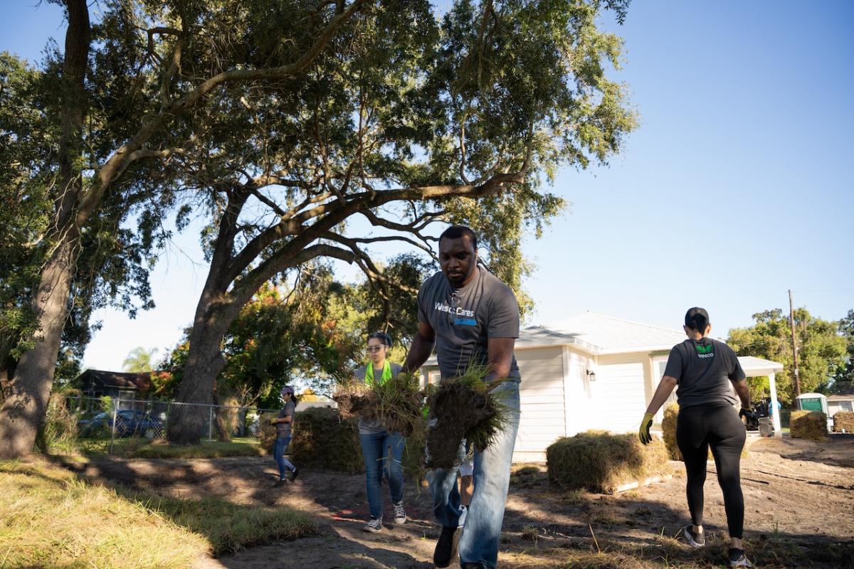 Wesco volunteer doing landscaping.