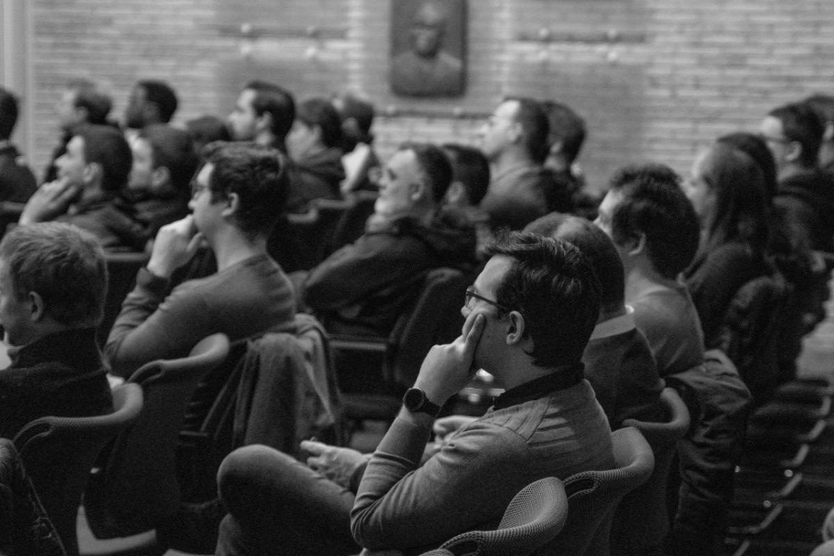 black and white photo of CNH colleagues attending the Team Innoptus presentation