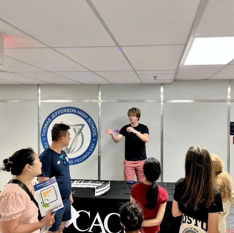 A student speaking to a small crowd