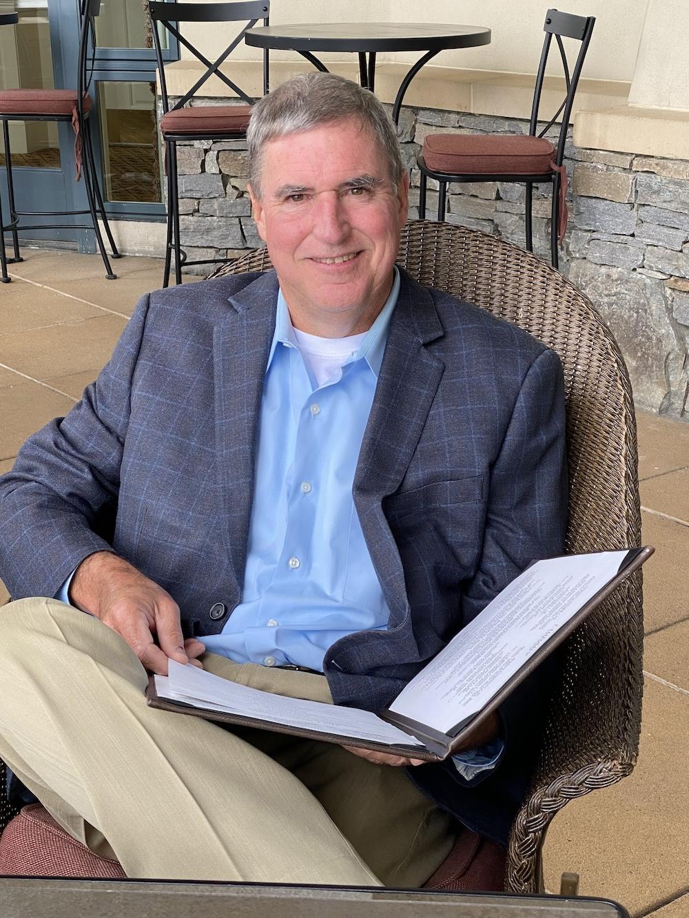 Terry Gwinn holding open binder