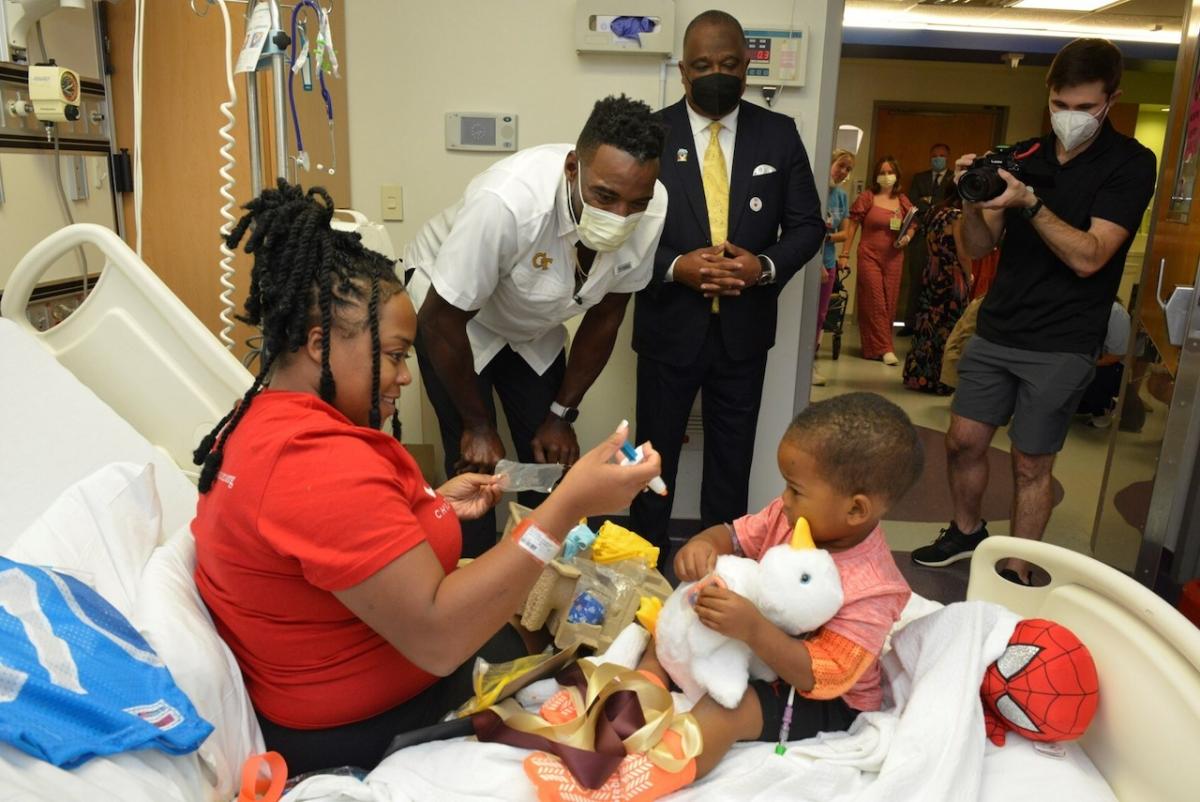 Photo: Hall of Fame football player Calvin "Megatron" Johnson Jr. delivers a My Special Aflac Duck® to a patient at The Aflac Cancer and Blood Disorders Center at Children's Healthcare of Atlanta as part of Aflac's Kickoff for a Cause football game in Atlanta. Hall of Fame football player Calvin "Megatron" Johnson Jr. delivers a My Special Aflac Duck to a patient at The Aflac Cancer and Blood Disorders Center at Children's Healthcare of Atlanta as part of Aflac's Kickoff for a Cause football game tonight in Atlanta.