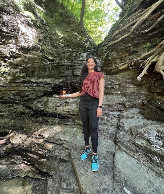 Thelma Gomes posing on the edge of a rocky outcrop.