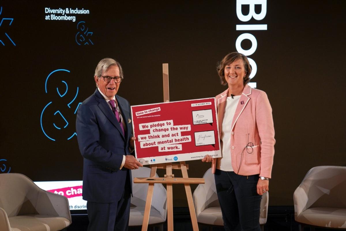 Peter T. Grauer, Chairman, Bloomberg L.P. and Jo Loughran, Director of Time to Change sign the Time to Change employer pledge in London