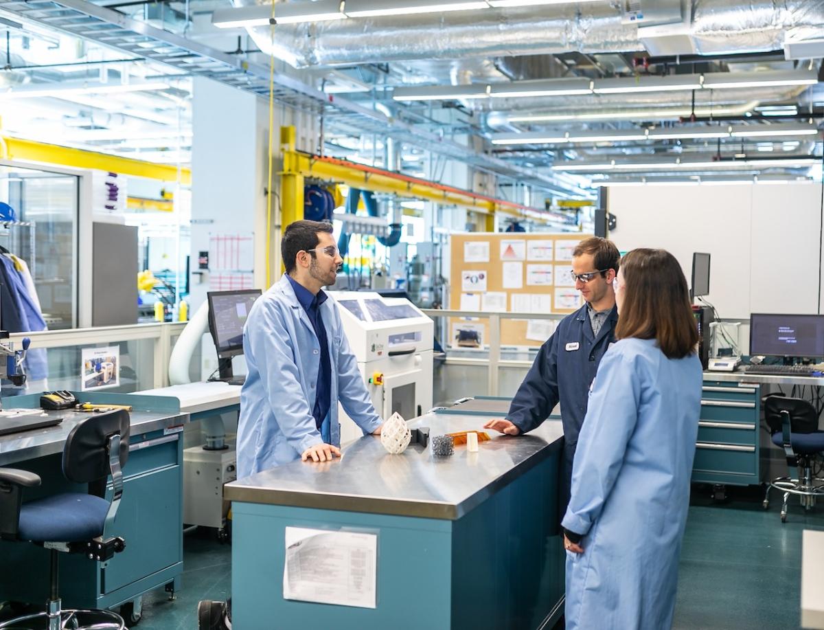 Three people working on a design problem.