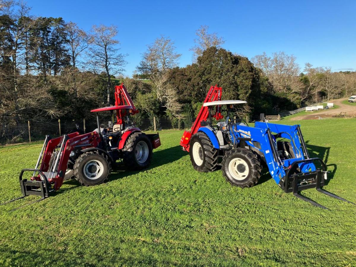 Two tractors parked next to each other in a field