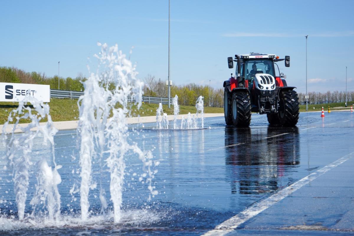 Tractor in front of a water fountain