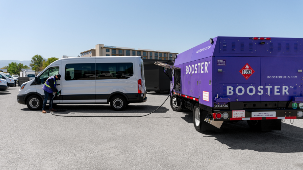 Booster's mobile fueling service increases productivity, saves on fueling costs, and boosts sustainability. Booster service professional fuels a white van.