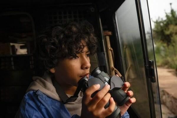 young person holding binoculars