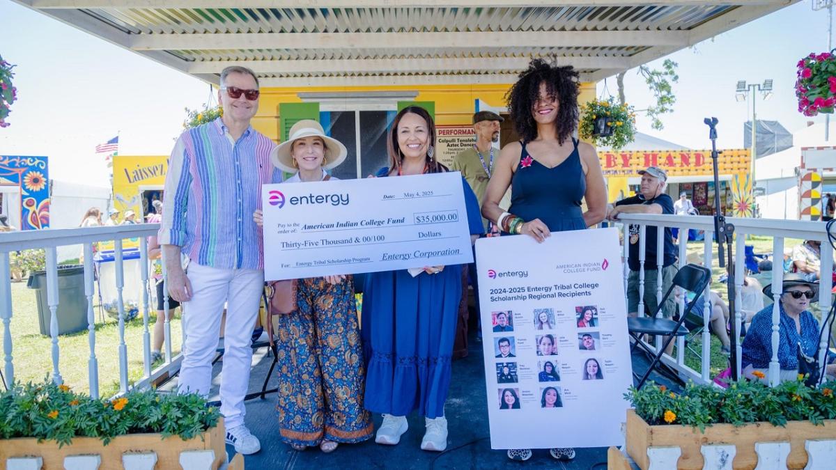 4 people with a large check